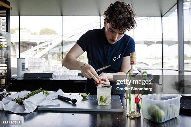 Barman prepares a caipirinha cocktail in the guest lounge bar on board Hotel OFF Paris Seine in Paris, France, on Wednesday, July 20, 2016. The...