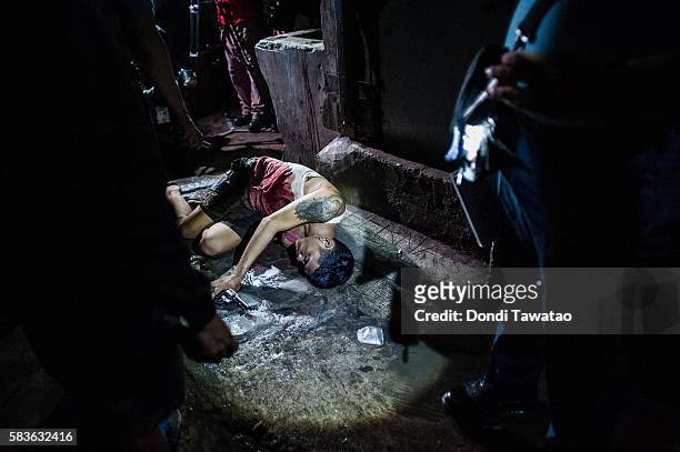 Police examine the body of an alleged drug dealer killed in a shooutout with swat teams during a drug raid on July 21, 2016 in Manila, Philippines....