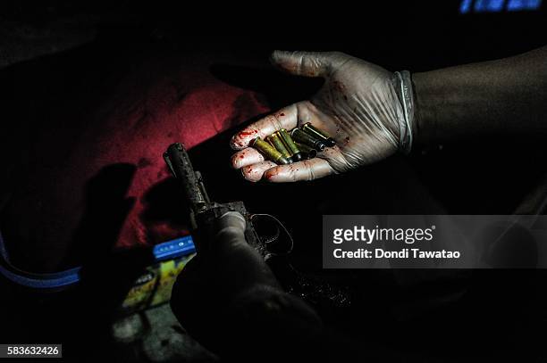 Police show a hand gun and spent shells taken during a drug raid which killed an alleged drug suspect on July 9, 2016 in Manila, Philippines....