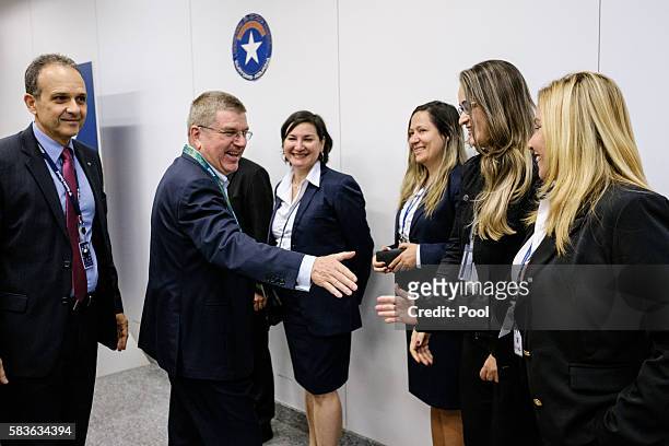 President of the International Olympic Committee Thomas Bach greets Brazilian customs officers on his arrival for Rio 2016 Olympic games at Antonio...