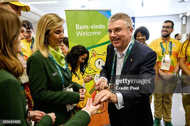 President of the International Olympic Committee Tomas Bach delivers Olympic pin badges on his arrival for Rio 2016 Olympic games at Antonio Carlos...