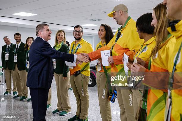 President of the International Olympic Committee Thomas Bach is welcomed by volunteers on his arrival for Rio 2016 Olympic games at Antonio Carlos...