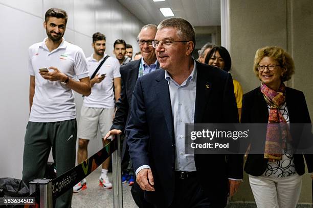 President of the International Olympic Committee Tomas Bach and his wife Claudia carry walk beside Iranian athletes on their arrival for Rio 2016...