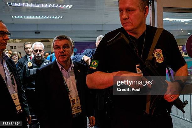 President of the International Olympic Committee Tomas Bach is escorted by a Brazilian Police officer on his arrival for Rio 2016 Olympic Games at...