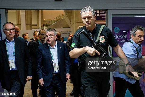 President of the International Olympic Committee Tomas Bach is escorted by a Brazilian Police officer on his arrival for Rio 2016 Olympic Games at...