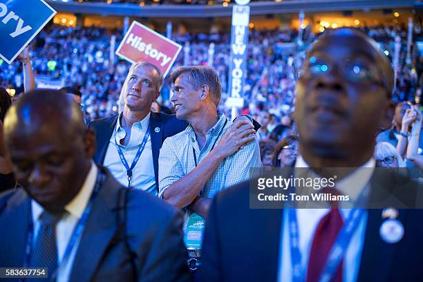 Rep. Sean Patrick Maloney, D-N.Y., and his husband, Randy Florke, back right, appear on the floor of the Wells Fargo Center in Philadelphia, Pa., on...