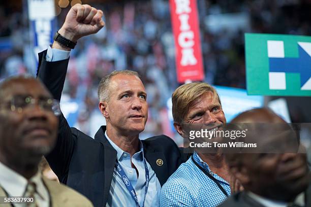 Rep. Sean Patrick Maloney, D-N.Y., back left, and his husband, Randy Florke, are seen on the floor of the Wells Fargo Center in Philadelphia, Pa., on...