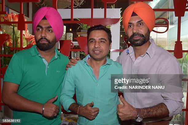 Indian actors Binnu Dhillon , Ammy Virk and director Pankaj Batra pose during a promotional event for the upcoming Punjabi film 'Bambukat' in...