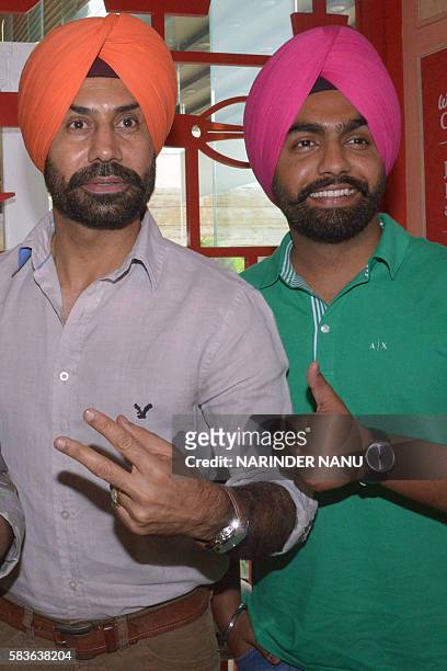 Indian actors Binnu Dhillon and Ammy Virk pose during a promotional event for the upcoming Punjabi film 'Bambukat' in Amritsar on July 27, 2016. /...