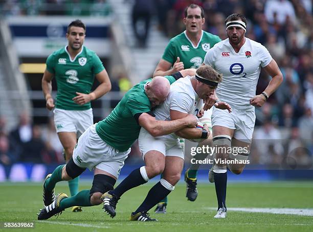 Tom Youngs of England is tackled by Paul O'Connell of Ireland during the QBE International match between England and Ireland at Twickenham Stadium in...