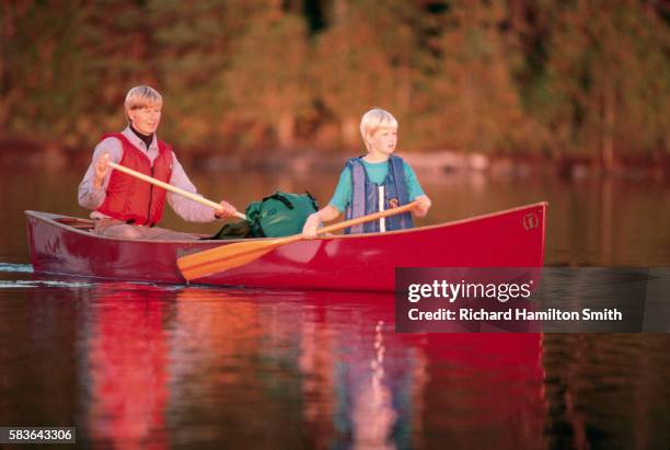 father & daughter in red canoe - family red canoe stock pictures, royalty-free photos & images