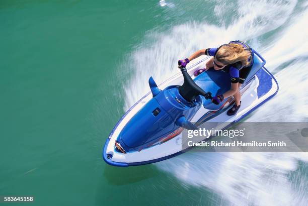 woman riding jet ski fast - jet boat fotografías e imágenes de stock