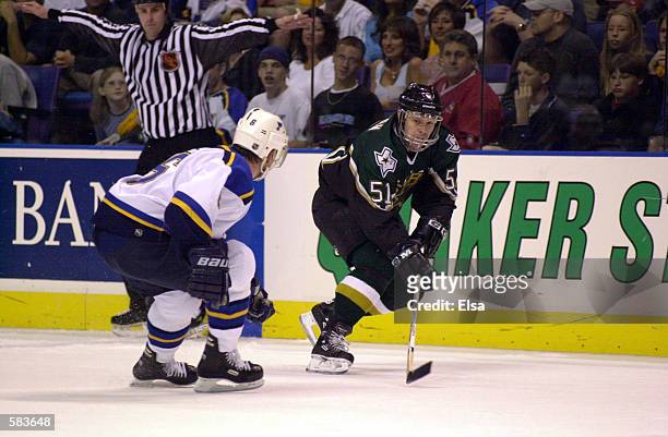 John Maclean of the Dallas Stars battles for the puck with Sean Hill of the St. Louis Blues during game 3 of Western Conference Semifinals at the...