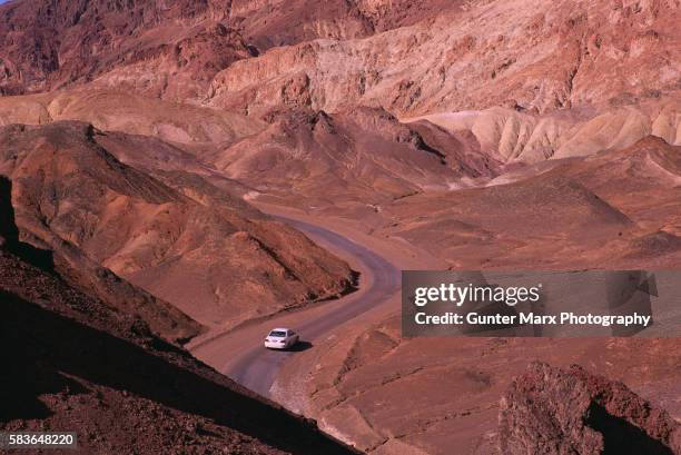 car driving through death valley - death valley road stock-fotos und bilder