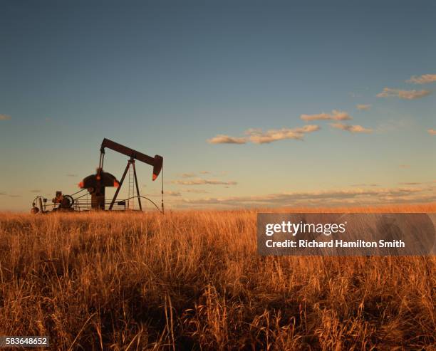 oil well in field - oklahoma stock pictures, royalty-free photos & images