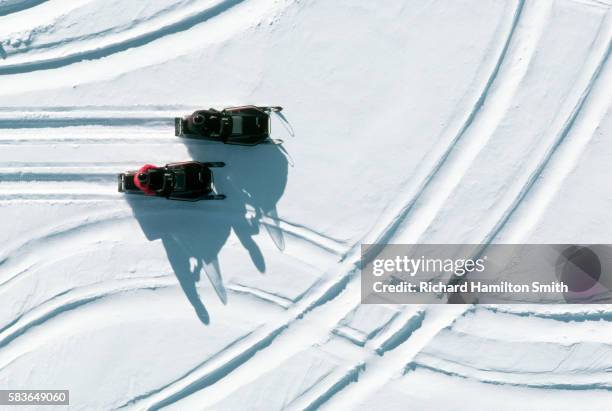 snowmobiles and tracks in snow field - snowmobiling stock-fotos und bilder