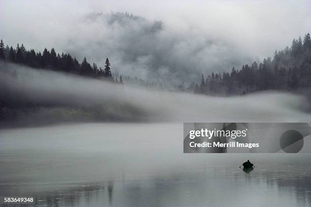 rowboat on mist covered ross lake - rowboat stock pictures, royalty-free photos & images