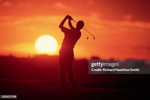 golfer swinging at sunset - golf swing sunset stock pictures, royalty-free photos & images