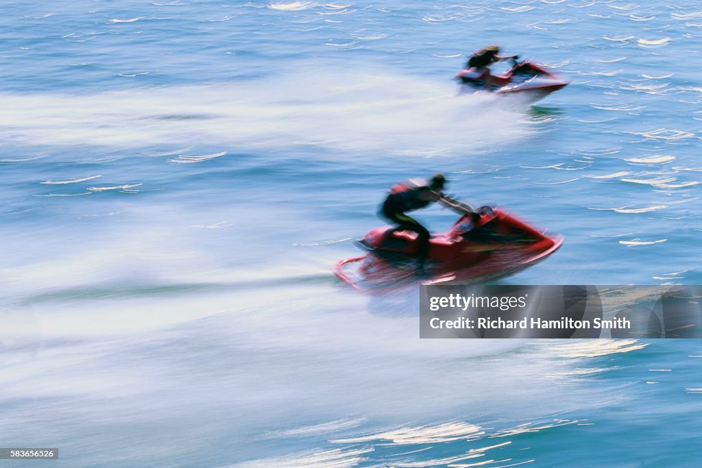 People Racing Jet Skis