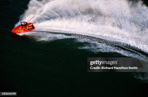 water splashing behind jet skier - jet boat fotografías e imágenes de stock