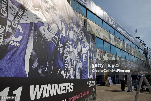 Poster of the 2011 League Cup winning team on display outside the Spion Kop stand at St. Andrew's stadium with the city's skyline in the distance,...