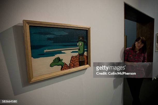 Woman looking at the painting entitled 'Ellipsis ' by Rene Magritte. An exhibition of the artist's work will open at Tate Liverpool on 24 June, 2011...