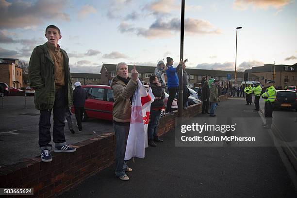 Portsmouth fans waving and gesturing to rival Southampton fans in a convoy of buses driving away from Fratton Park stadium after the teams...