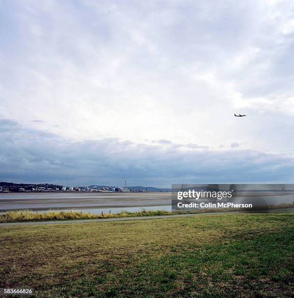 Passenger aircraft landing at Liverpool airport by the river Mersey. The Mersey is a river in north west England which stretches for 70 miles from...