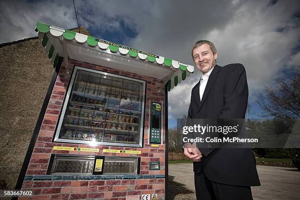 Peter Fox, standing beside the giant vending machine he has designed and installed in the tiny Derbyshire village of Clifton. The fully automated...