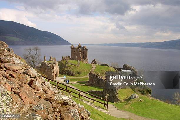 The ruined Urquhart Castle towering over the western shore of Loch Ness at Drumnadrochit. The loch is famed for the mythical monster Nessie which has...