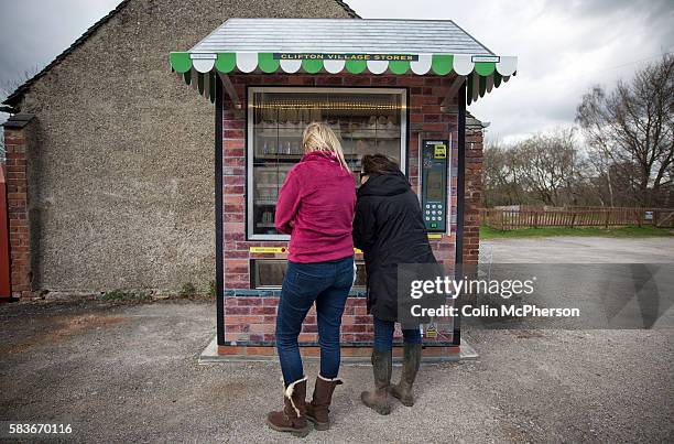 Two potential customers looking at items in the giant vending machine designed and installed by local businessman Peter Fox in the tiny Derbyshire...