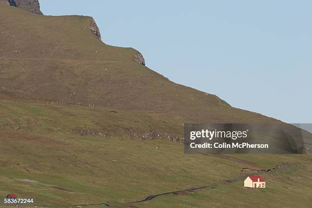 An isolated house on a hillside close to the village of Midvágur, a renowned location for the Faroe Islands whaling industry, and near to the Faroe...