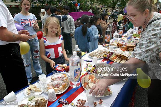 Revellers enjoying a special buffet at a Golden Jubilee street party in Jubilee Street in the Stepney Green area of east London, where hundreds...