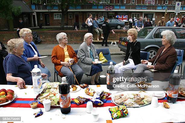 Residents at a special buffet during a Golden Jubilee street party in Jubilee Street in the Stepney Green area of east London, where hundreds turned...