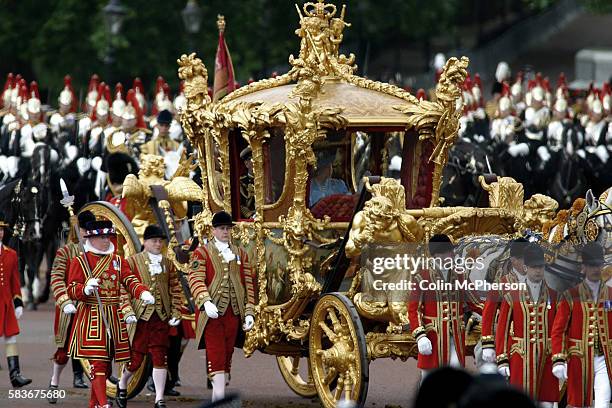 Queen Elizabeth II emerges through the gates of Buckingham Palace on her ceremonial journey through London to St. Paul's cathedral where she attended...