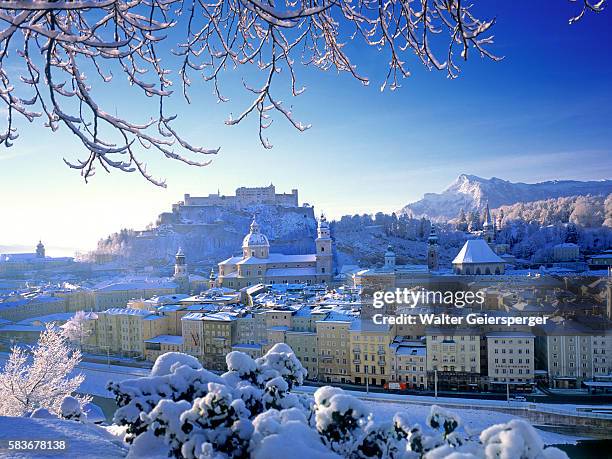 salzburg blanketed in snow - österreich winter stock-fotos und bilder