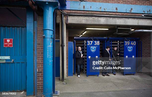 Portsmouth fans coming through turnstiles at the main entrance to Fratton Park stadium before their club take on local rivals Southampton in a...