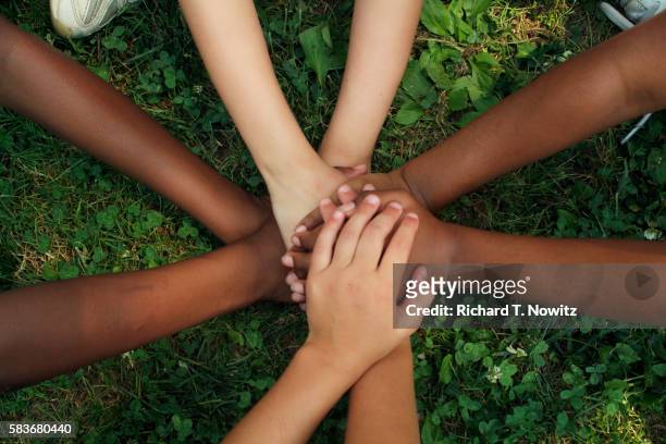 hands of children playing game - ethnicity stock pictures, royalty-free photos & images