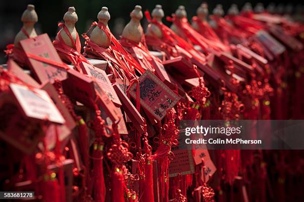 Wooden tablets left by visitors and disciples hanging from railings at the Confucius Temple and Guozijian in Beijing, China. The complex was first...