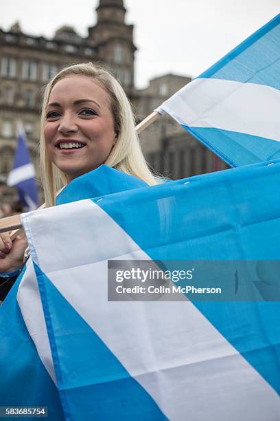 Woman with a Scottish saltire flags at a pro-independence gathering in George Square, Glasgow. The gathering brought together Yes Scotland supporters...