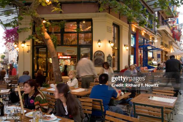 dining at restaurant in plaka - plaka greek cafe stock pictures, royalty-free photos & images