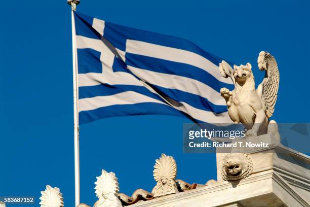 greek flag and griffin statue at zappeion - griffioen stockfoto's en -beelden