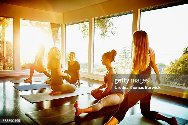 Smiling group of women stretching after yoga class