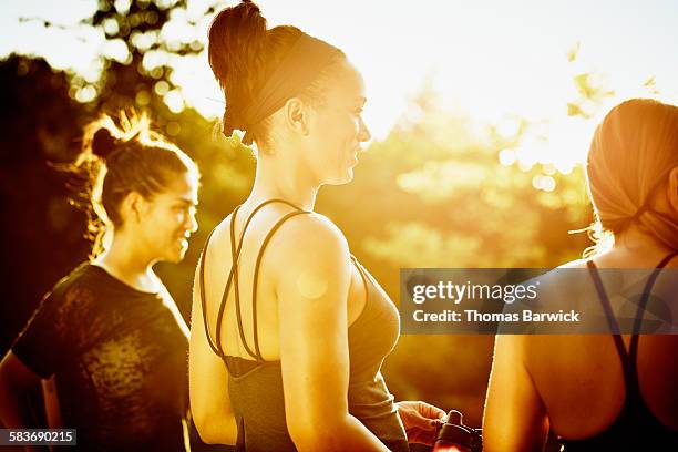 Smiling friends watching sunset after yoga class