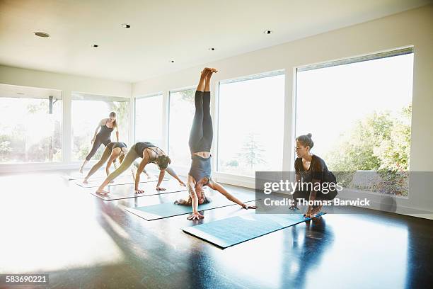 Yoga student warming up with headstand