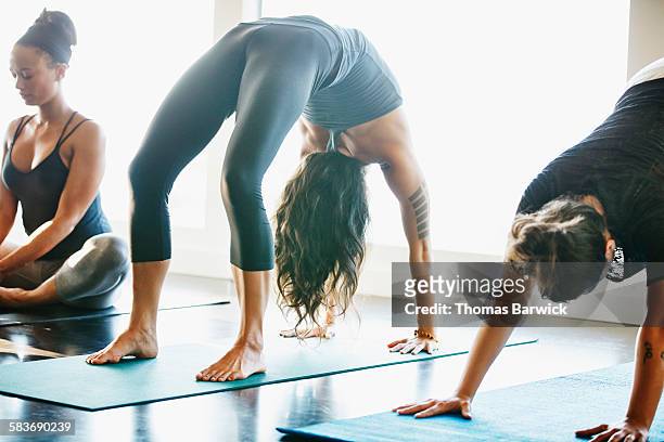 Woman in upward bow pose in yoga studio
