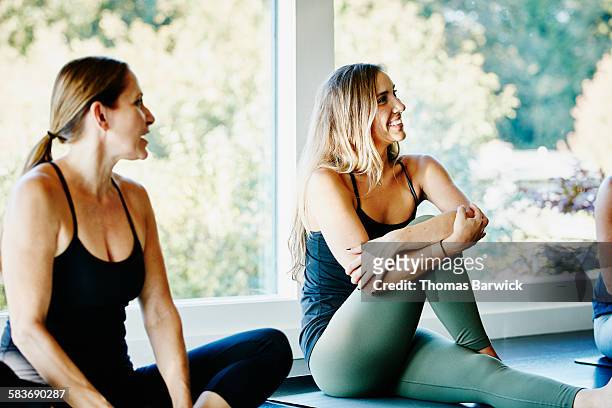 Smiling woman stretching before yoga class