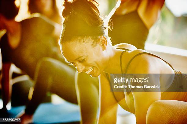 Woman laughing with friends during yoga class