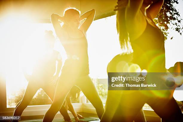 Women stretching and preparing for yoga class