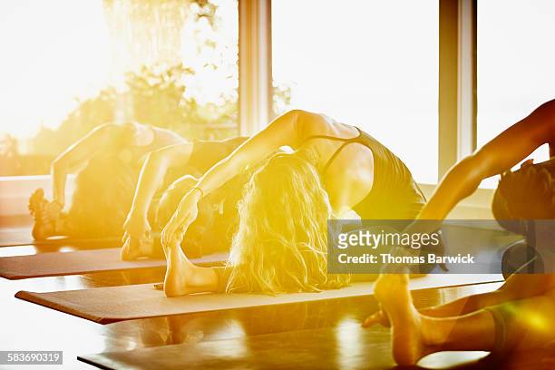 Women practicing yoga in monkey king pose